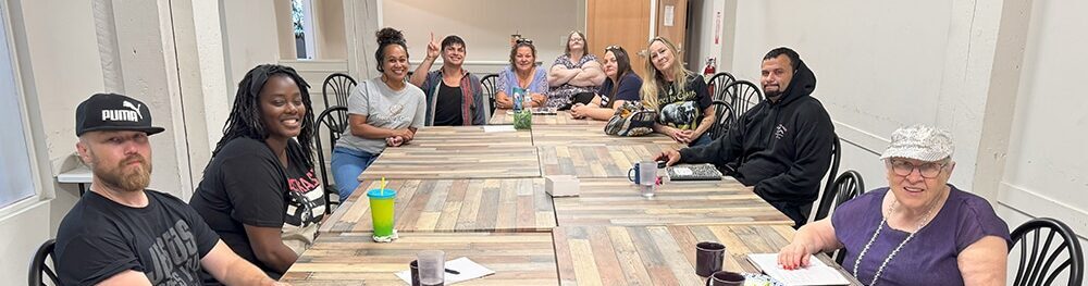people sit around a conference table